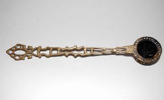 Antique Brass Candle Snuffer With Ornate Handles photo