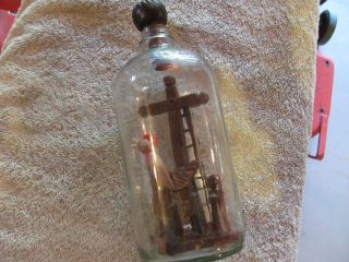 Religious Carving In A Bottle. photo