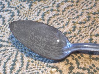 Old Very Long Gray Graniteware Stirring Soup Spoon. photo