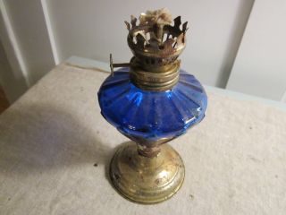 Tiny Little Oil Lamp With Blue Glass.  Design. photo
