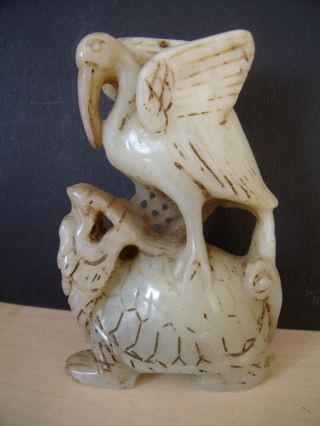 Jade Carving Of A Stork Stood On Top Of A Dragon photo