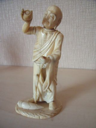 Japanese Carved Okimono Of A Man With A Stick photo