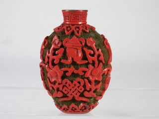 Good Two Color Chinese Cinnabar Lacquer Snuff Bottle With Buddhist Symbols photo
