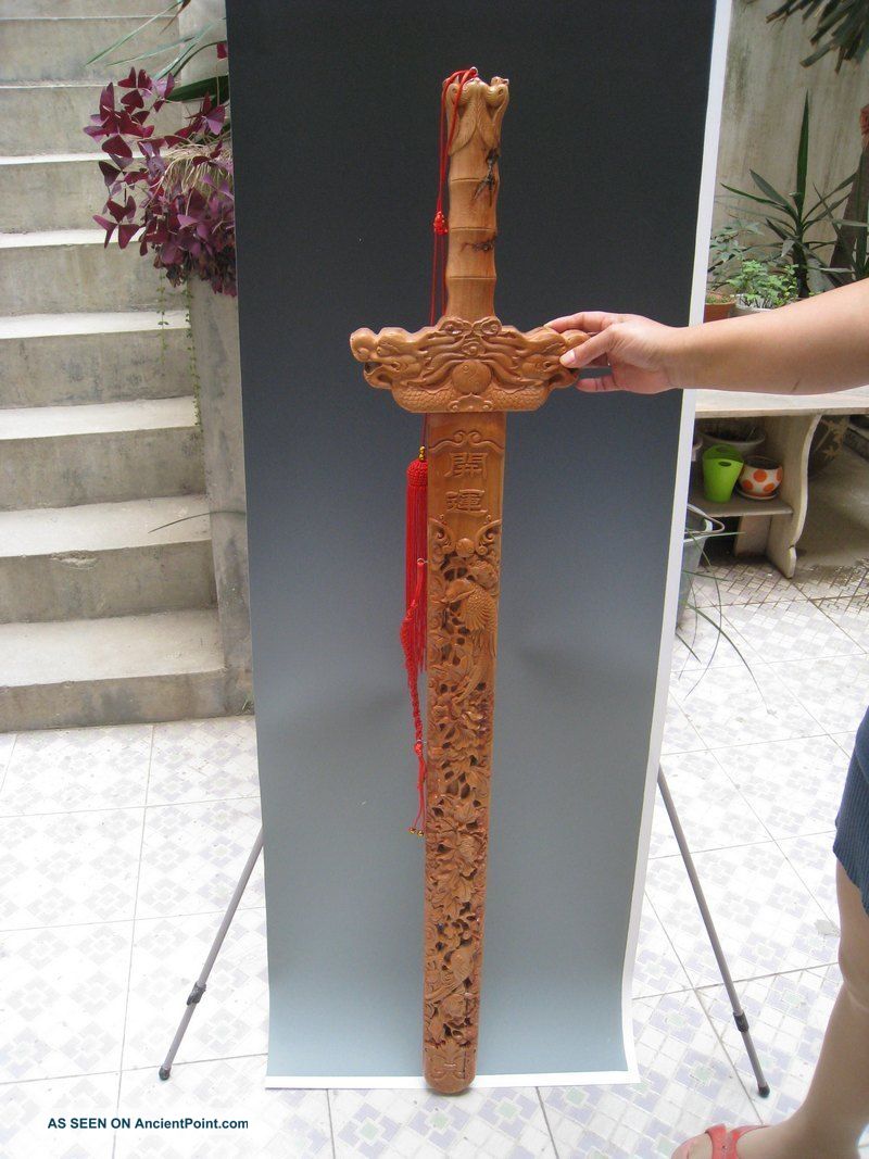 China Yangzhou Hand Openwork Carving Wood Carving Tao Mujian Swords photo