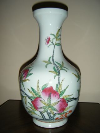 Old Porcelain Vase With Peach Branch And Leaves Design photo