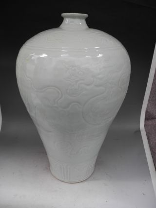 Chinese White Glaze Carved Dragons Porcelain Vase photo