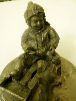 Cute Vtg Pewter Little Boy Sitting On Sleigh Playing With A Puppy Dog Figure photo
