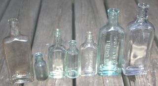 7 Antique Vintage Old Clear Green Blue Glass Cork Top Embossed Bottles photo