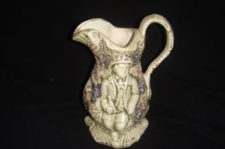 Pitcher Grape Vine With Two Raised Figures One On Each Side photo