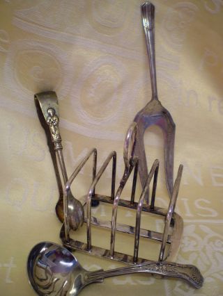 A Vintage Silver Plate Toast Rack,  Sauce Ladle,  Apostle Sugar Tongs & Bread Fork photo