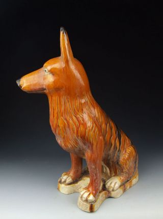 One Tri - Colored Pottery Dog Statue photo