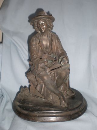 Antique Metal Spelter Of Fish Monger With Horn And Knapsack On Oval Base photo