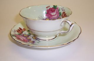 Paragon Tea Cup & Saucer Large Colorful Flowers On Soft Green Background photo