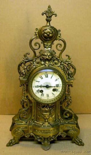 Antique Ad.  Mougin French Mantel Clock Decorative Brass Lion Paw Feet Urn Flower photo