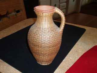 Pottery Pitcher That Is Cane Covered photo