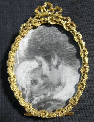 A Luois Xv Gilded Bronze Oval Frame. photo