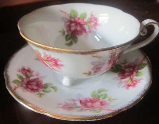 Three Footed Porcelain Cup And Saucer,  Gold Rimmed,  Ring Of Roses Theme photo