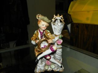 Boy With Horn Sitting On Bench By Lamp Post Porcelain Figurine No Breaks photo