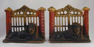 Antique Cast Iron Bookends Lion In Front Of Metal Gate photo