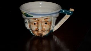 Antique Cup With Face Of An Old Man photo