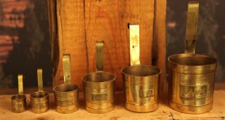 Compete Of Six Set Of Brass Nesting Measuring Cups photo