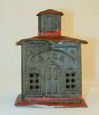 Antique Tin Penny Bank In The Form Of A Bank Building With Red Painted Roof photo