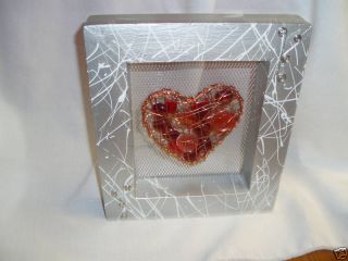Copper Heart Filled With Glass In Wooden Silver Frame photo