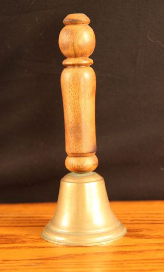 Antique Brass Bell With A Wooden Handle photo