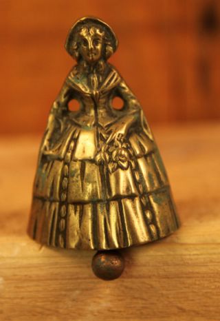 Antique Brassbell Lady Holding Posy Of Flowers photo