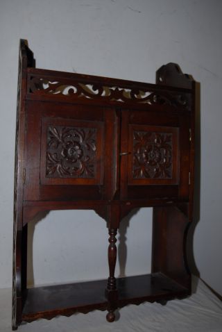 An Antique Floral Carved Wood 2 - Door Hanging Cabinet With Shelf photo