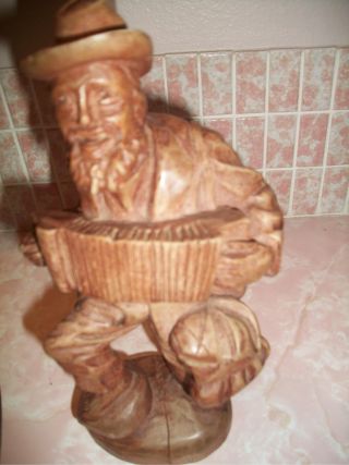 Folk Are Carved Wood Man With Accordian photo
