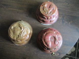 A Set Of Three Antique Copper Jello Molds photo