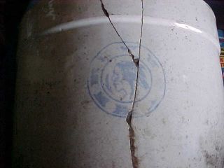 Old White Crock With Indian Head Emblem photo