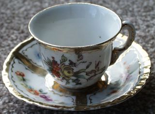 Miniature Antique Cup And Saucer With Gilding photo