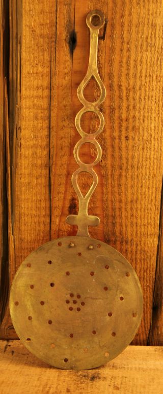 Large Antique Brass Strainer With Ornate Handle photo