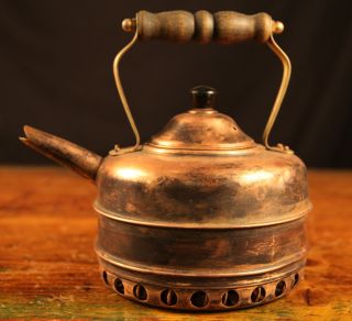 Antique Copper Kettle With A Wooden Handle photo