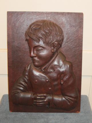 Antique Carved Wooden Wall Plaque Of Boy. photo