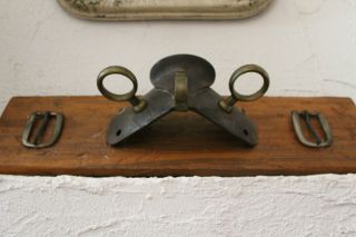 Antique Horse Drawn Carriage Rein Holder And Buckles Mounted On Old Barn Wood photo