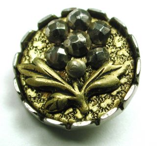 Antique Steel Cup Button W Cut Steel Flower And Brass Texture Background photo