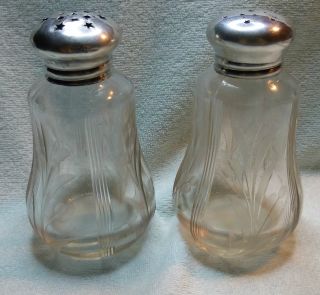 A Pair Of Glass And Sterling Salt & Pepper Shakers photo