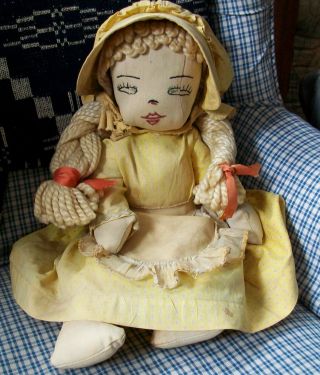 Antique Vintage Cloth Rag Doll With Yellow Yarn Hair And Sun Faded Yellow Print photo