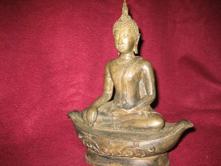 Bronze Sukhothai Buddha Statue Seated On Boat photo