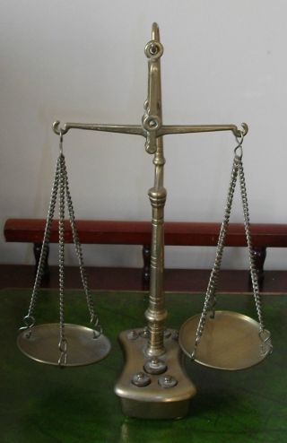 A Set Of Brass Scales With Weights photo