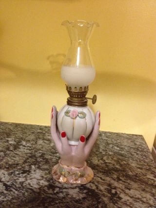 Hand Painted Porcelain Hands Holding Oil Lamp photo