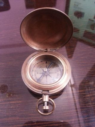 18th Century Style Nautical Compass Push Button Directional Compass In Antique. photo