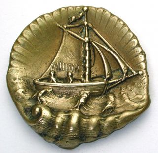 Lg Sz Antique Brass Button Couple In Sailboat On Realistic Shell Background photo