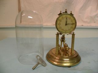 Antique German Year Running Clock Under A Glass Dome photo
