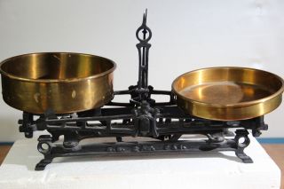 Antique Scale Is Cast Iron With Two Brass Weighing Plates photo
