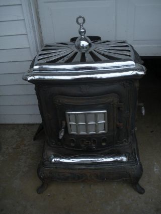 Vintage Cast Iron Parlor Wood Stove With Chrome Accents photo