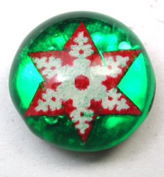 Antique Kaleidoscope Button Snowflake Design On Green Background photo